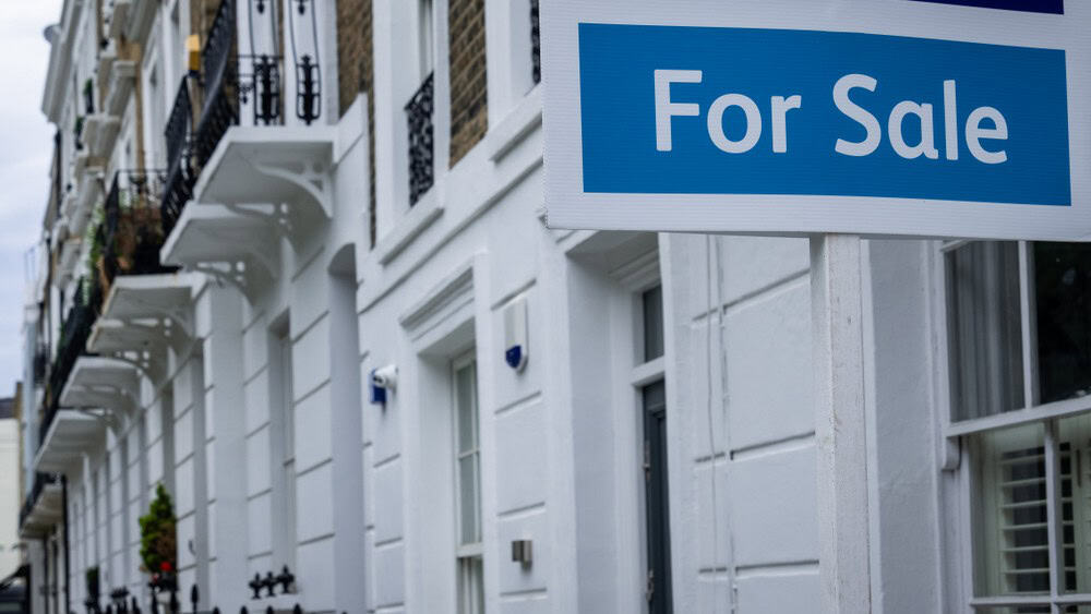 Estate agent 'for sale' sign on attractive London street