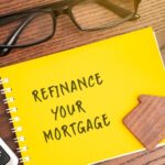 Refinance your mortgage concept. Process of obtaining a new loan to replace an existing home loan, often to secure better terms. Real estate and finance. Notebook, house and calculator on table