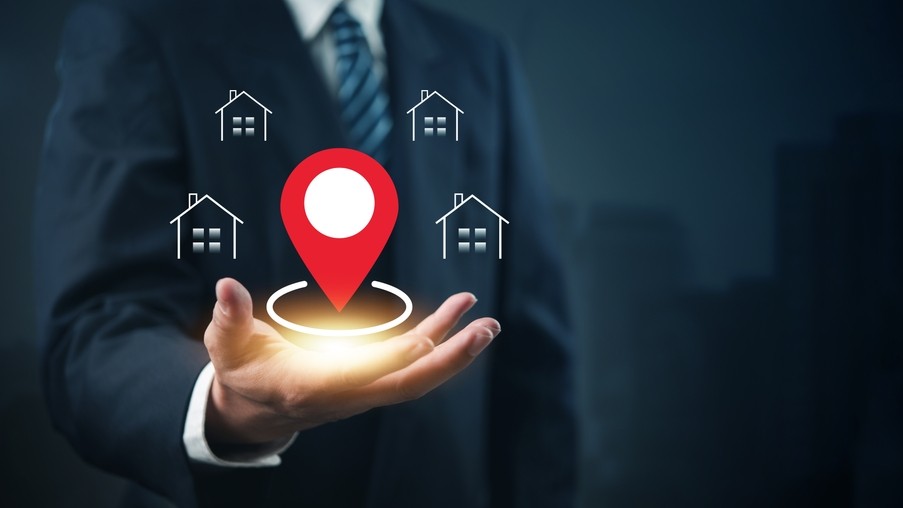 Real estate location concept with GPS pin and house icons, representing property search, map-based home listings, and smart housing navigation.