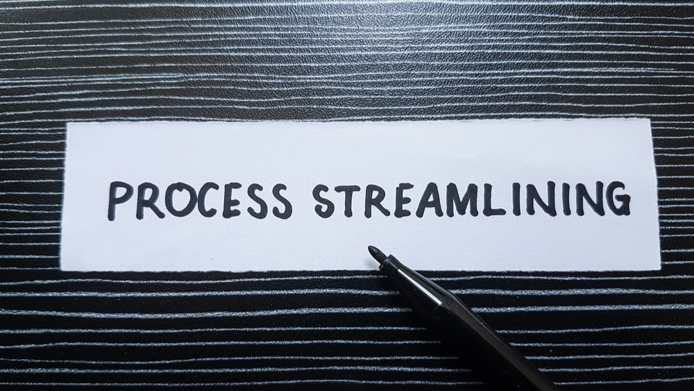 Process streamlining writting on table background.