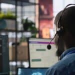 Customer center expert uses AI assistant to generate technical solutions for clients. Call center agent uses artificial intelligence LLM chatbot to provide step by step guidance to customers, camera A