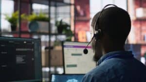 Customer center expert uses AI assistant to generate technical solutions for clients. Call center agent uses artificial intelligence LLM chatbot to provide step by step guidance to customers, camera A