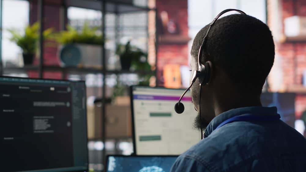 Customer center expert uses AI assistant to generate technical solutions for clients. Call center agent uses artificial intelligence LLM chatbot to provide step by step guidance to customers, camera A