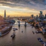 Panoramic aerial view of the skyline of London, England, with Tower Bridge, River Thames and City skyscrapers during a colorful sunset