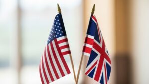 Close-up of elegant miniature USA and UK flags side by side, symbol of alliance, diplomacy, partnership and strong international relations, premium look