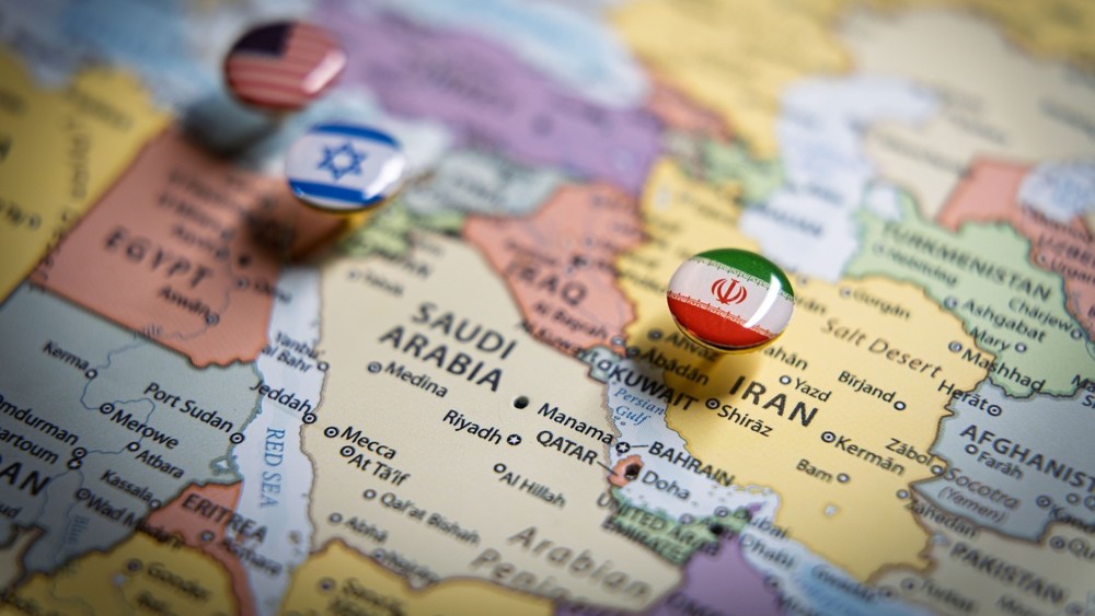 Political map of the Middle East with flag pins of USA, Israel, and Iran on key geographic locations, representing international relations and geopolitical alliance concept and war in middle east. High quality photo