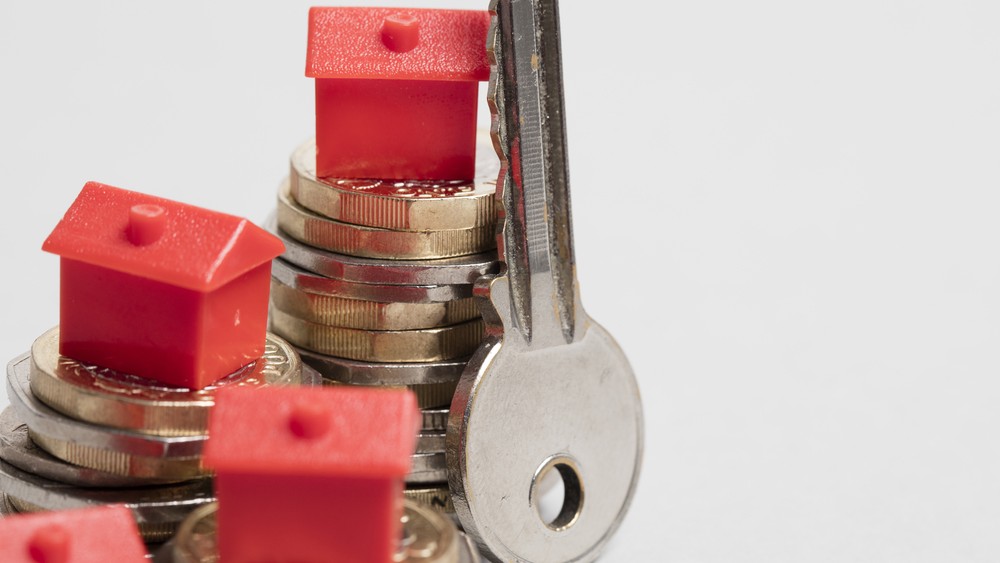 Housing cost. Red house with British currency